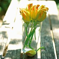 Courgette flowers in a glass of water