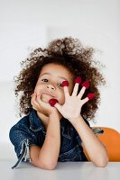 Young girl playing with raspberries