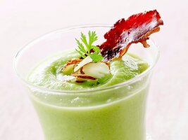 Cream of pea soup with crisp bacon and almonds