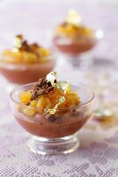 Chocolate mousse with stewed mangoes and golden flakes