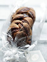 Chocolate yeast plait in cellophane paper