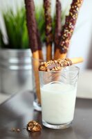 Sweet chocolate breadsticks and a glass of milk