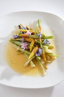 Plate of mini vegetables with edible flowers