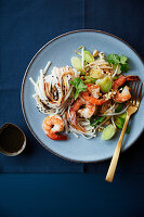 Jumbo shrimps with rice noodles,spring leeks,black sesame seeds and coriander