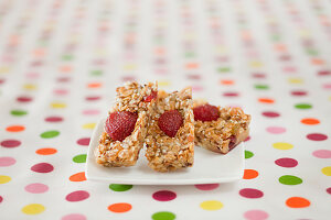 Muesli bars with strawberries on a dotted tablecloth