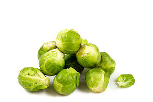 A small heap of Brussels sprouts on a white background