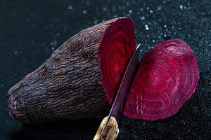 Slicing a beet on a black background