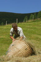 Dairyman with Willow Basket, Hay Harvest, Glettenalm, Nationalpark Hohe Tauern, Salzburger Land, Austria