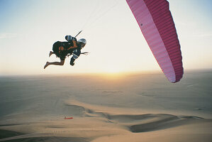 Paraglider over desert, Walfish Bay, Namibia