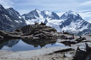 Hikers at the top of a mountain pass, Fuorcla Surlej, Bernina Range, Upper Engadin, Engadin, Grisons, Switzerland