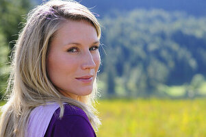 Young woman smiling at camera, lake Lautersee, Mittenwald, Werdenfelser Land, Upper Bavaria, Germany