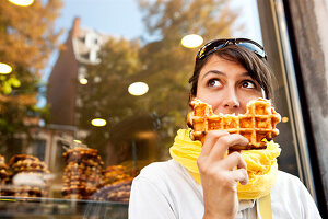 Woman eating a Belgian waffle, Liege, Wallonia, Belgium