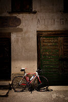 Bicycle leaning against an old house, Furkapass, Canton Uri and Wallis, Switzerland