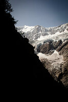 Hiker on mountain trail, on the way to Schreckhorn hut, Lower Grindelwald glacier, Bernese Oberland, Switzerland