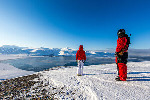 Couple enjoying the view towards Longyearbyen, Spitzbergen, Svalbard, Norway