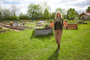 Woman in a garden holding carrotes