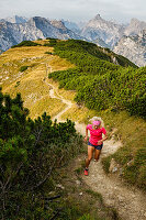 Trailrunner runs in a grandiose Karwendel panorama to the summit of Bärenkopf, Achensee, Tyrol, Austria