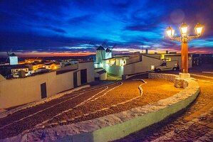 Street and windmills,night view. Campo de Criptana,Ciudad Real province,Castilla La Mancha,Spain.