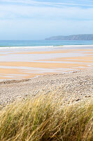 Beach with dunes and wooden fence at Vauville on the Cotentin Peninsula, Normandy