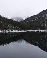Winter mountains reflected in Mittersee, Biberwier, Austria