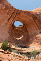 View of Bowtie Arch. Hole in the rock. Blue sky. Corona Arch Trail.