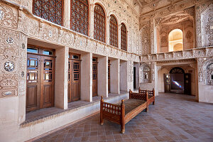 Terrace with intricate stucco decoration on the walls in the Tabatabaei House, a historic mansion built around 1880 in Kashan, Iran.