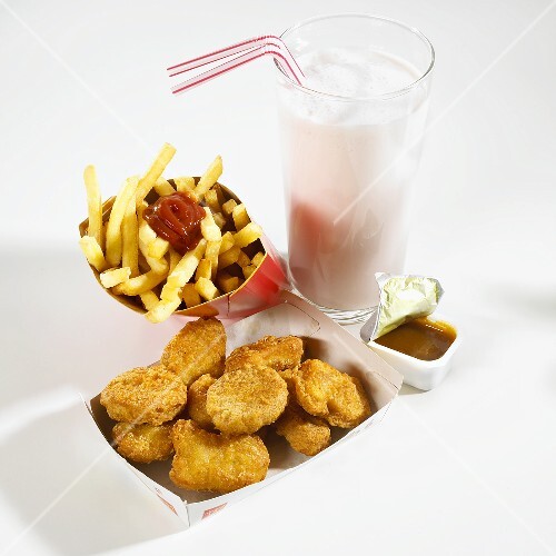 Chicken nuggets, chips, sauce and milkshake – buy images – StockFood