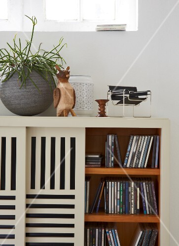 A Sideboard Used For Storing Cds With Slatted Sliding Doors