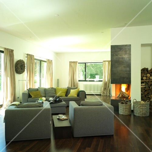 Living Room With Fire Place Gray Sofa And Cushions On Wooden