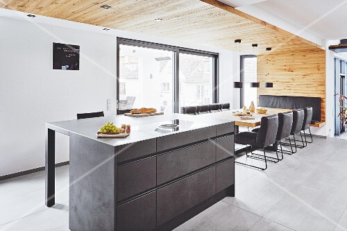 A Suspended Reclaimed Wood Ceiling Over An Island And Dining