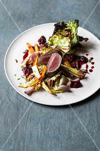 Oven-roasted savoy cabbage and venison with a port wine and cherry sauce and savoy cabbage crisps